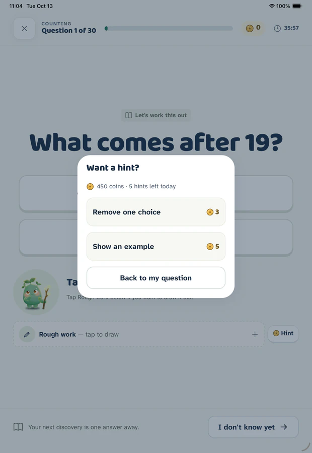 Gakumi hint menu on iPad over a dimmed worksheet, offering to remove one answer choice or show an example, with the coin cost of each shown.